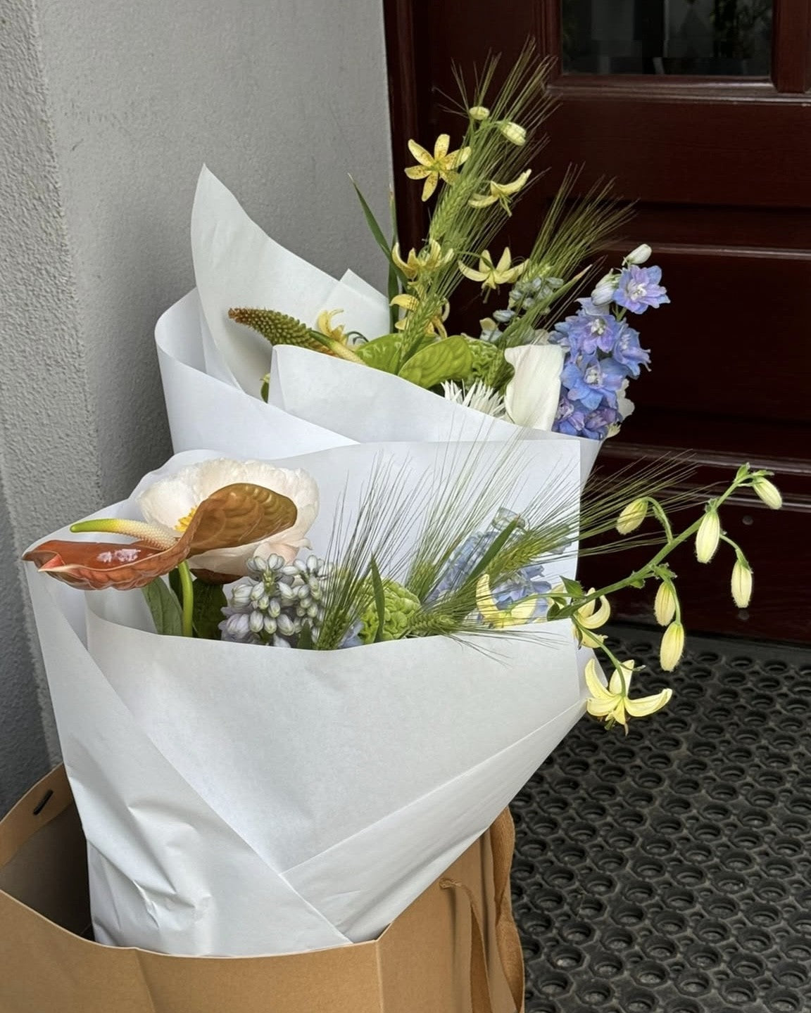 Floral subscription box with packaged flowers, care instructions, and arranging tools