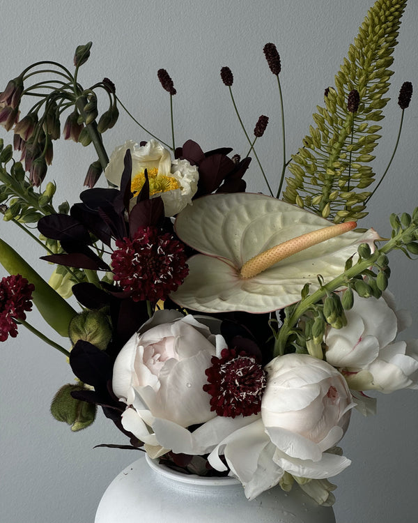 Garden style bouquet with seasonal flowers and botanical textures.